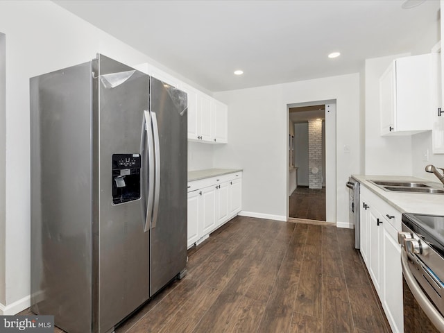 9732 Garis Shop Rd, Hagerstown, MD 21740 - kitchen featuring stainless steel appliances, a sink, baseboards, dark wood-type flooring, and light countertops