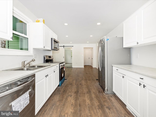9732 Garis Shop Rd, Hagerstown, MD 21740 - kitchen with appliances with stainless steel finishes, a sink, white cabinetry, dark wood-style floors, and recessed lighting