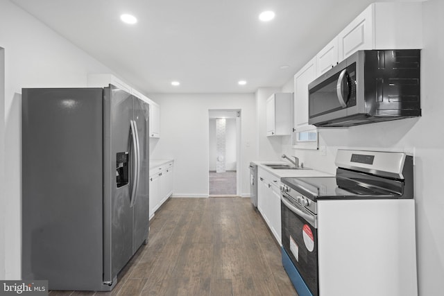 kitchen with sink, dark hardwood / wood-style flooring, white cabinets, and appliances with stainless steel finishes