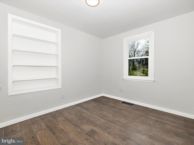 9732 Garis Shop Rd, Hagerstown, MD 21740 - empty room with baseboards, built in shelves, and dark wood-style floors