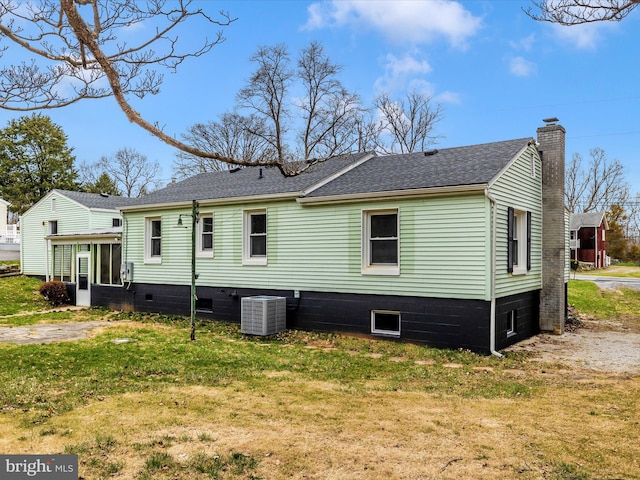 9732 Garis Shop Rd, Hagerstown, MD 21740 - back of house with cooling unit, a chimney, a lawn, a sunroom, and a shingled roof