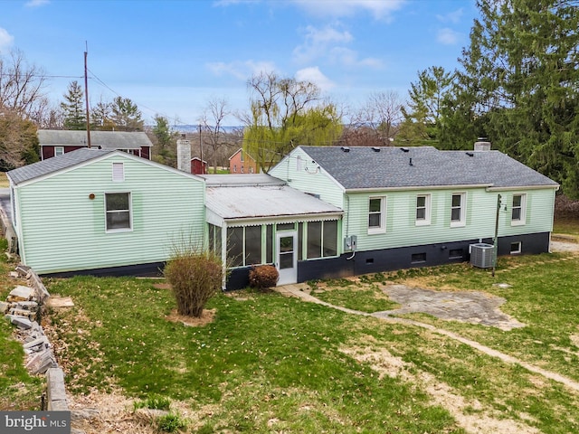 9732 Garis Shop Rd, Hagerstown, MD 21740 - back of property featuring a chimney, a sunroom, central air condition unit, a lawn, and a shingled roof