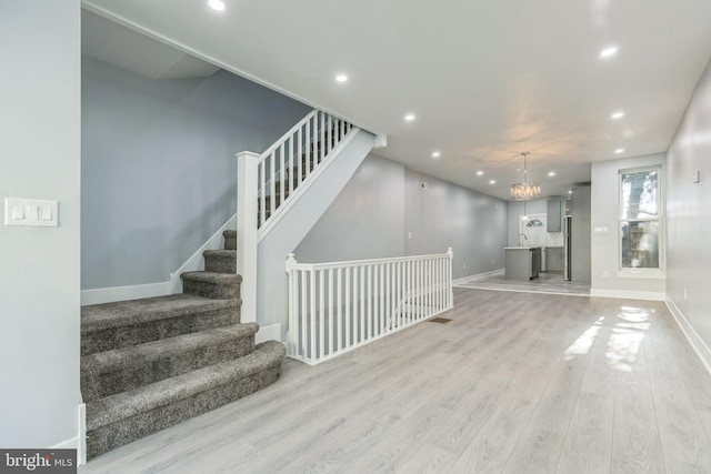 interior space with hardwood / wood-style floors and an inviting chandelier