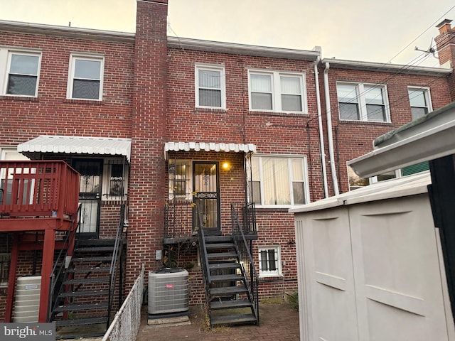 back of house featuring central AC