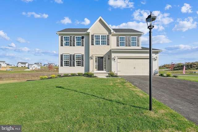 view of front of home featuring a garage and a front lawn