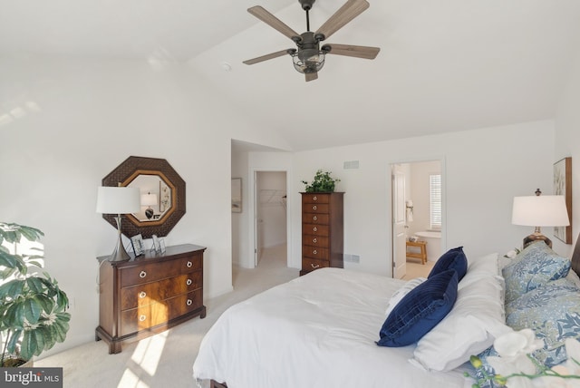 bedroom with ensuite bath, ceiling fan, lofted ceiling, a walk in closet, and light carpet