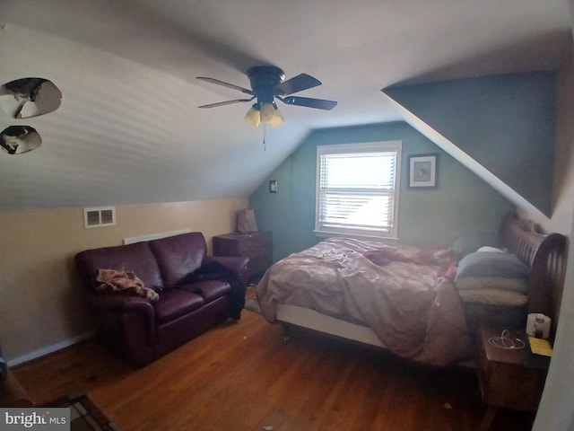 bedroom with ceiling fan, dark wood-type flooring, and vaulted ceiling