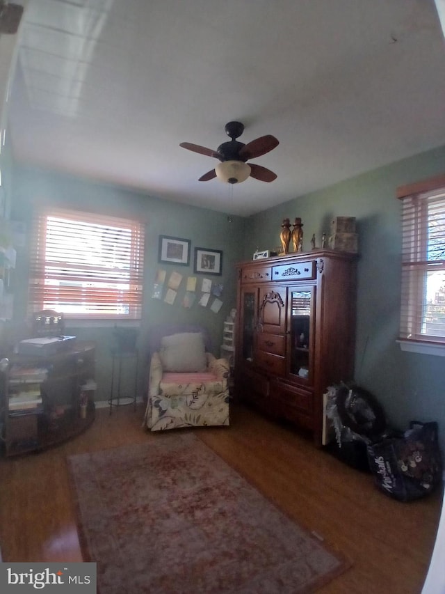 living area with ceiling fan and hardwood / wood-style floors