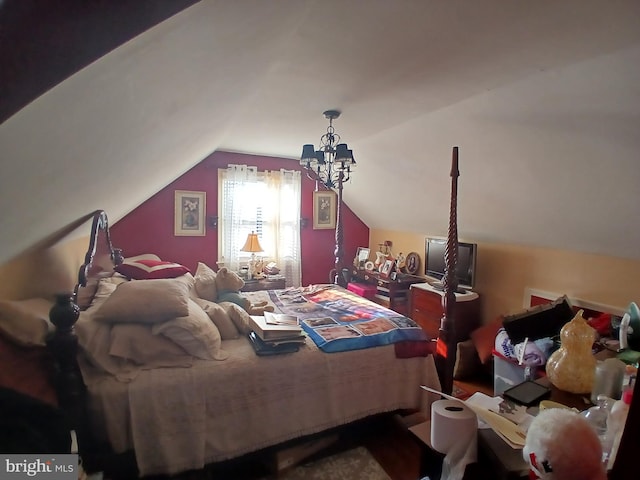 bedroom featuring a chandelier and vaulted ceiling