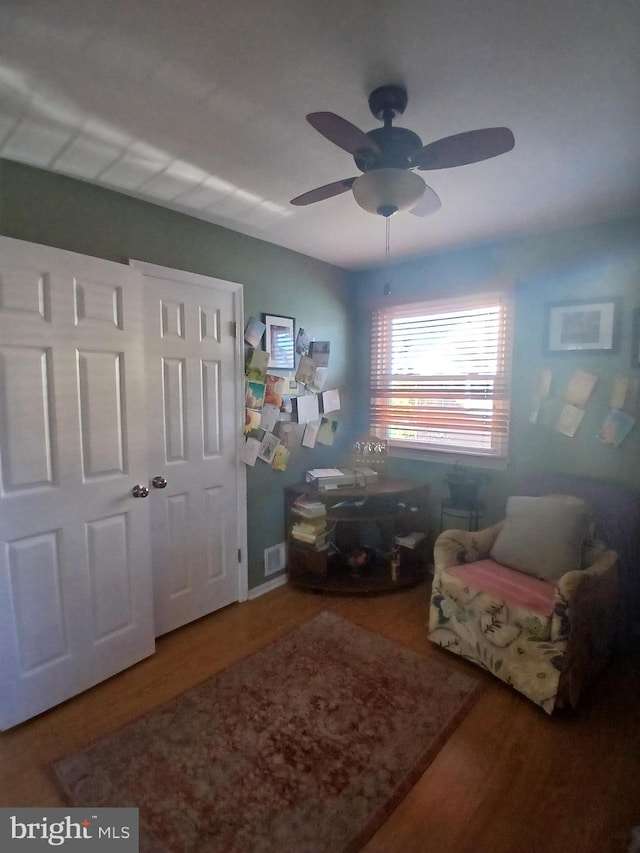 sitting room featuring ceiling fan and wood-type flooring