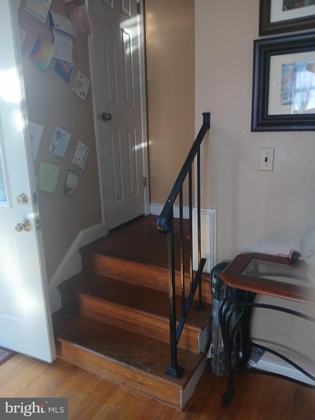 stairs featuring wood-type flooring