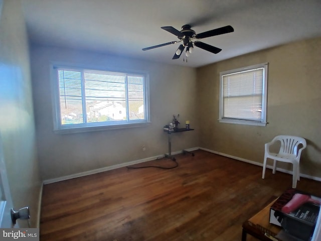 unfurnished room with dark hardwood / wood-style flooring and ceiling fan