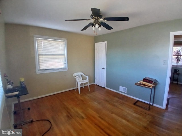 interior space featuring ceiling fan and dark hardwood / wood-style flooring