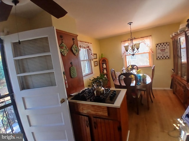 dining area featuring hardwood / wood-style floors and an inviting chandelier