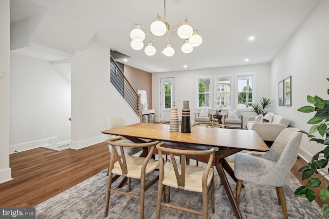 dining area featuring a notable chandelier and dark hardwood / wood-style floors