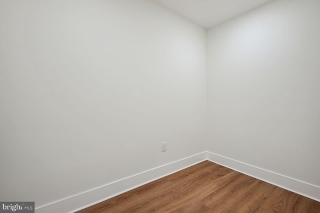 empty room with wood-type flooring