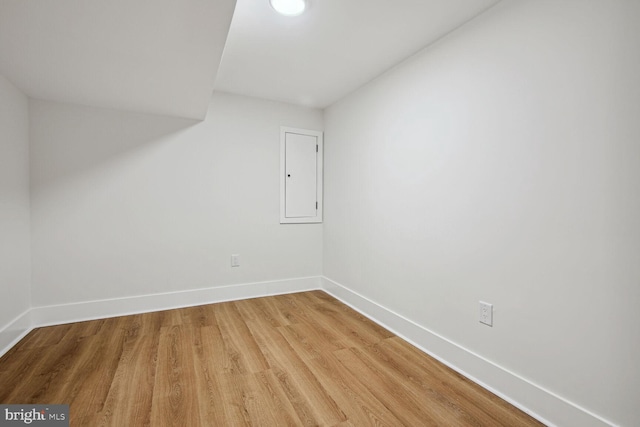 bonus room with hardwood / wood-style floors and electric panel