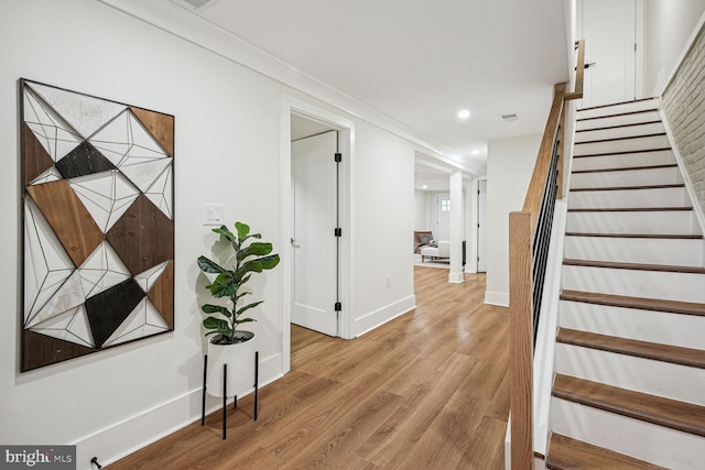 interior space featuring hardwood / wood-style flooring and ornamental molding