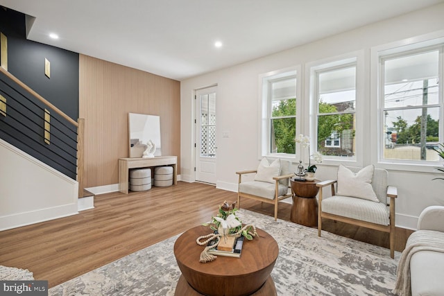 living room with wood-type flooring and a healthy amount of sunlight