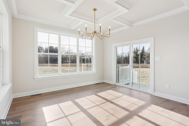 interior space featuring beamed ceiling, hardwood / wood-style flooring, coffered ceiling, crown molding, and an inviting chandelier