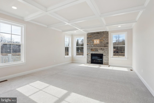 unfurnished living room featuring coffered ceiling, a fireplace, and light carpet