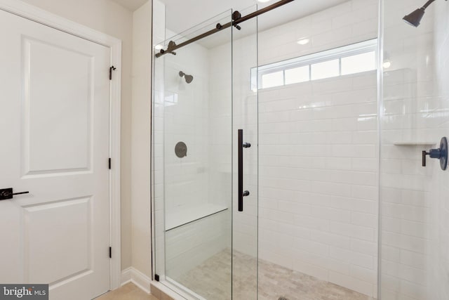 bathroom with a shower with shower door