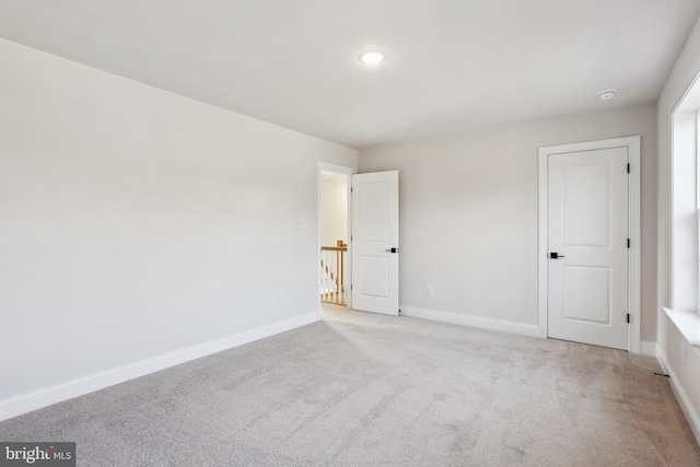 empty room featuring light colored carpet