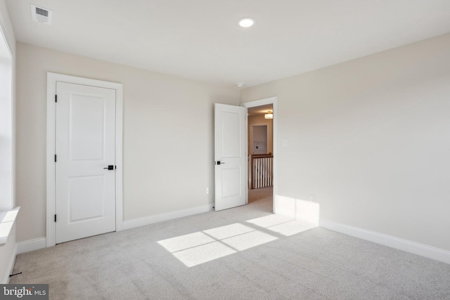 unfurnished bedroom with light colored carpet