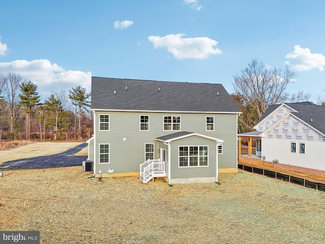 rear view of property featuring central air condition unit