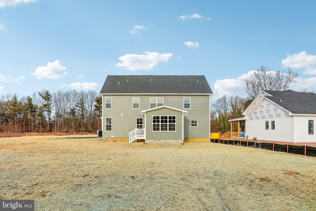 rear view of house with a yard