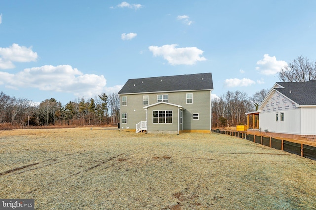 rear view of house with a yard