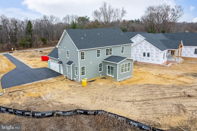 rear view of property featuring a garage