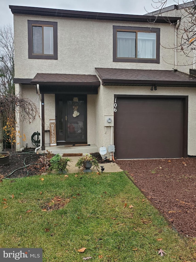 view of front of property featuring a garage and a front lawn