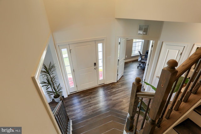 entryway featuring dark hardwood / wood-style floors and a high ceiling