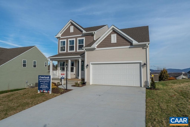 view of front of home featuring a front yard, a porch, and central air condition unit