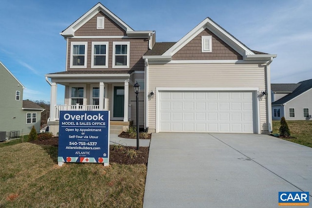 craftsman-style house featuring central AC and a garage