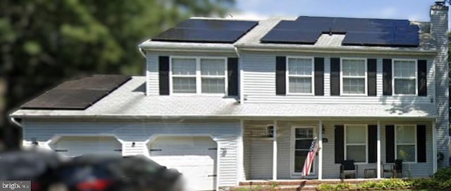 view of front facade with a porch and solar panels