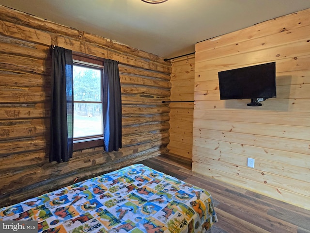 unfurnished bedroom with dark hardwood / wood-style flooring and wooden walls