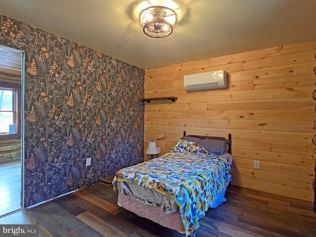 bedroom featuring dark hardwood / wood-style floors, an AC wall unit, and wood walls