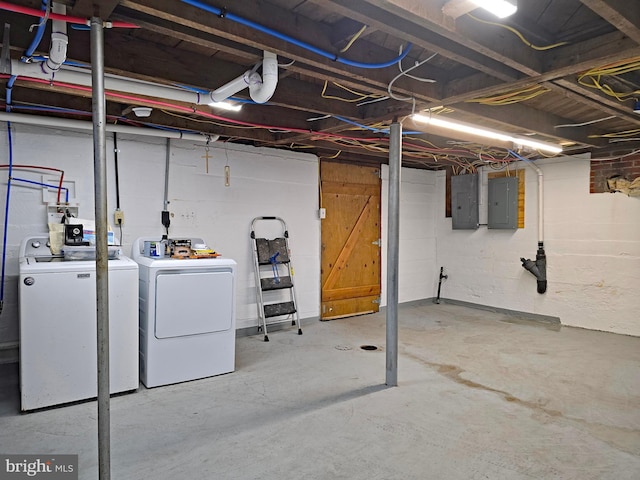 basement featuring electric panel and washer and dryer