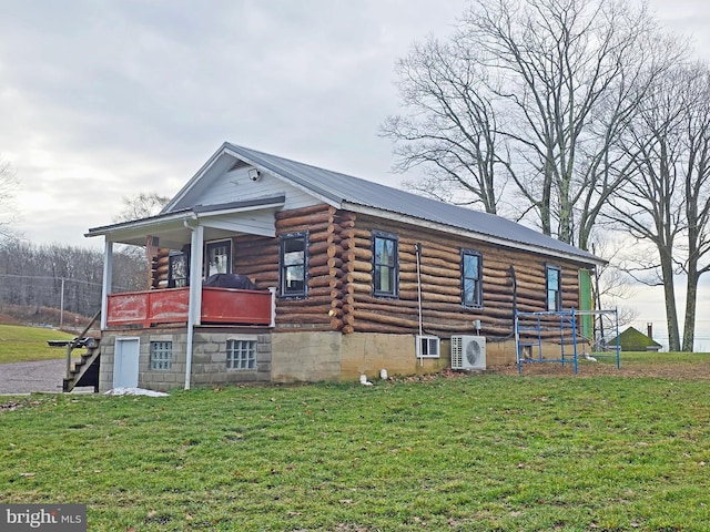 exterior space with ac unit and a yard