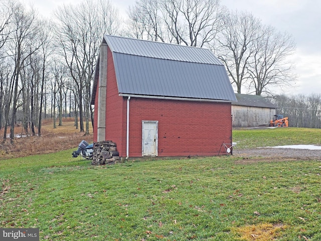 view of outbuilding with a yard