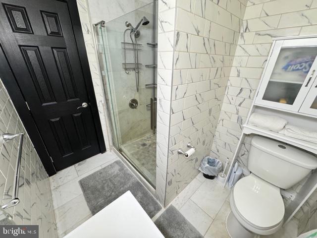 bathroom with toilet and walk in shower