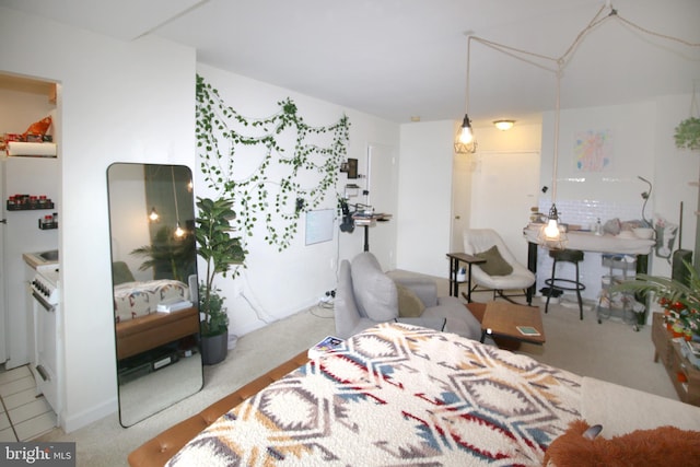 carpeted bedroom featuring white refrigerator