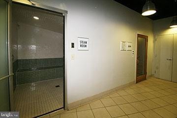 hall featuring light tile patterned floors