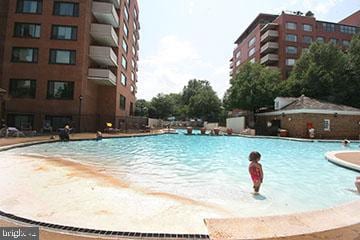 view of pool with a beach view