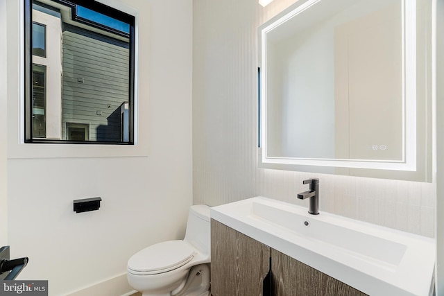 bathroom featuring vanity and toilet