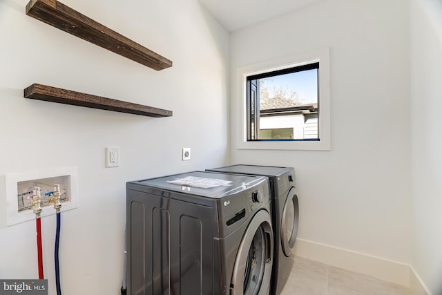 washroom with light tile patterned flooring and washer and clothes dryer