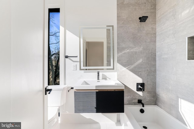 full bathroom featuring vanity, toilet, and tiled shower / bath combo