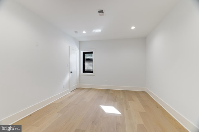 empty room with light hardwood / wood-style flooring